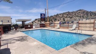a pool in front of a hill at Cedar City RV Resort