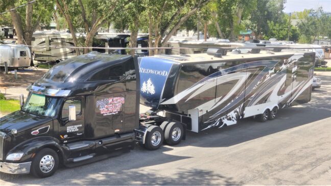 Semi-truck pulling a RV.