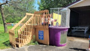 a purple dunk tank with young boys playing at Baraboo RV Resort