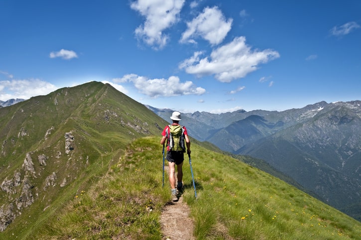 Man trekking along a mountain trail.