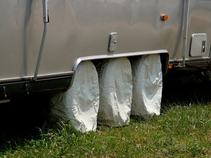 RV wheels have individual white covers on to protect them.