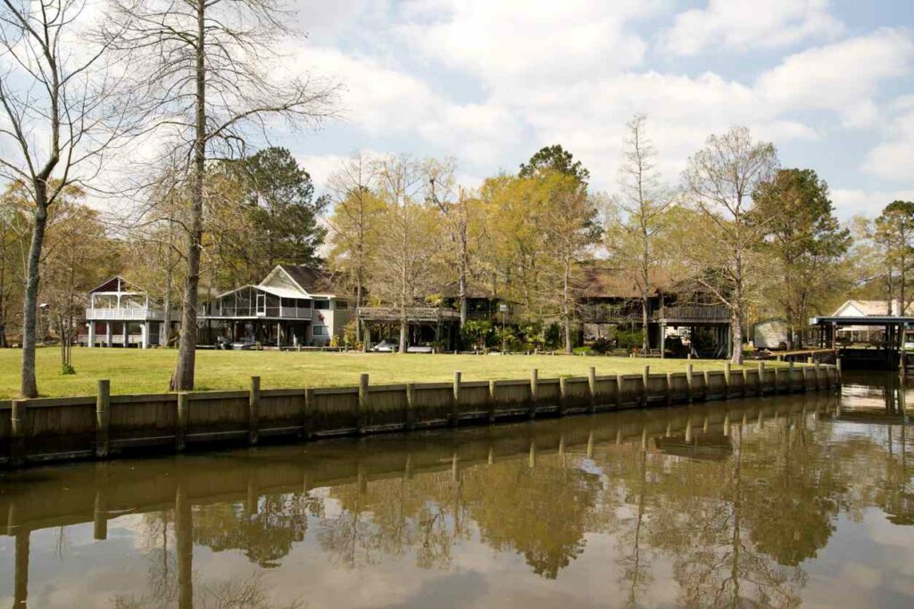 A view of water in front of houses on a lake