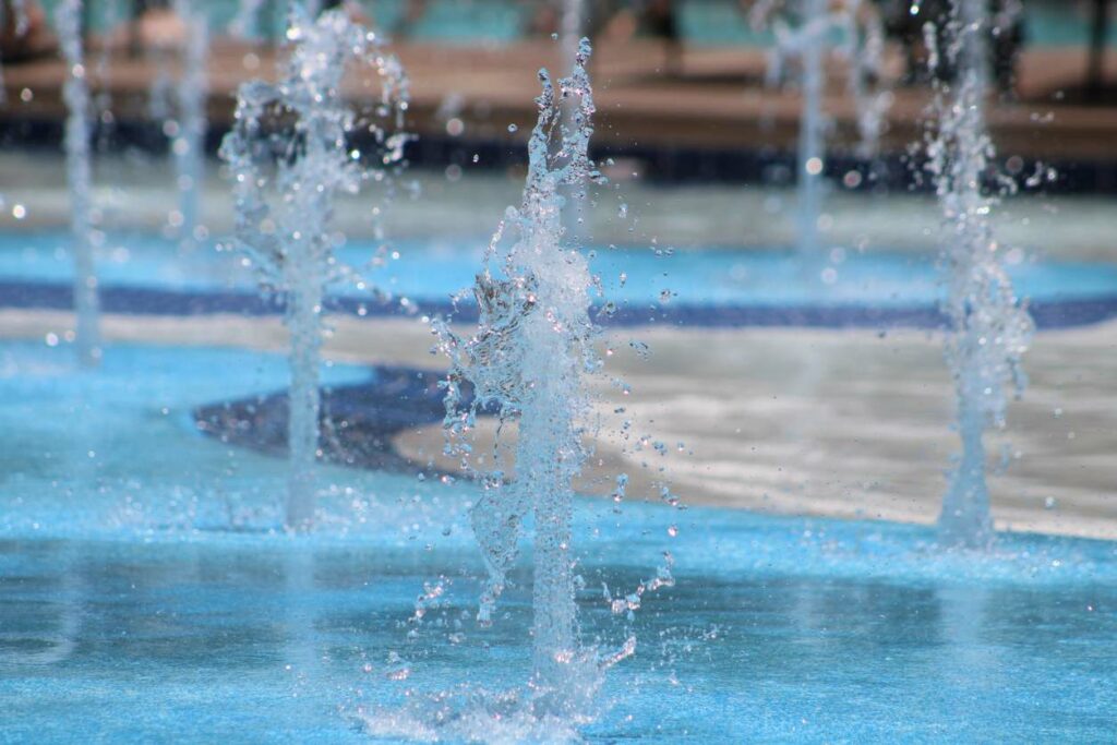 A splash pad shoots water vertically 