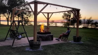 Bonfire by the lake during sunset.