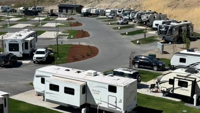 RV's at campsites with nicely mowed grass.