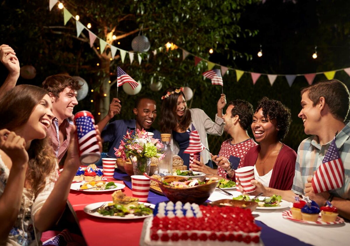 People gathered together with food for a Fourth of July party.