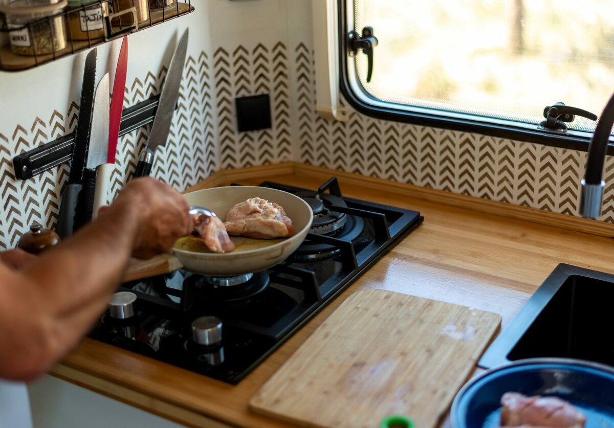 Shot of a man cooking a healthy meal on his RV stovetop.