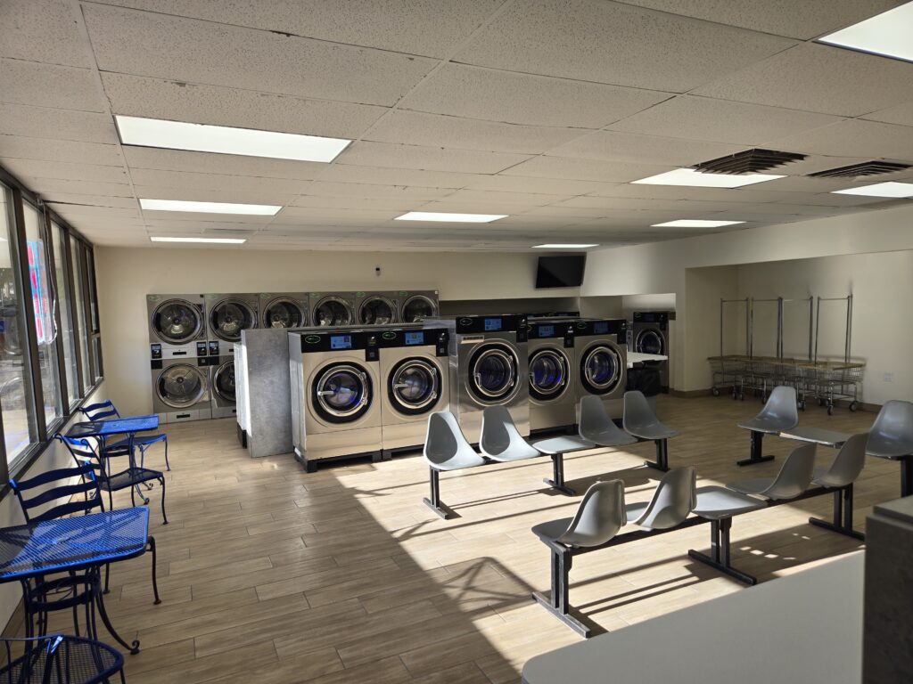 Interior of Cedar City Laundromat next to Cedar City RV Resort, with rows of new washers and dryers