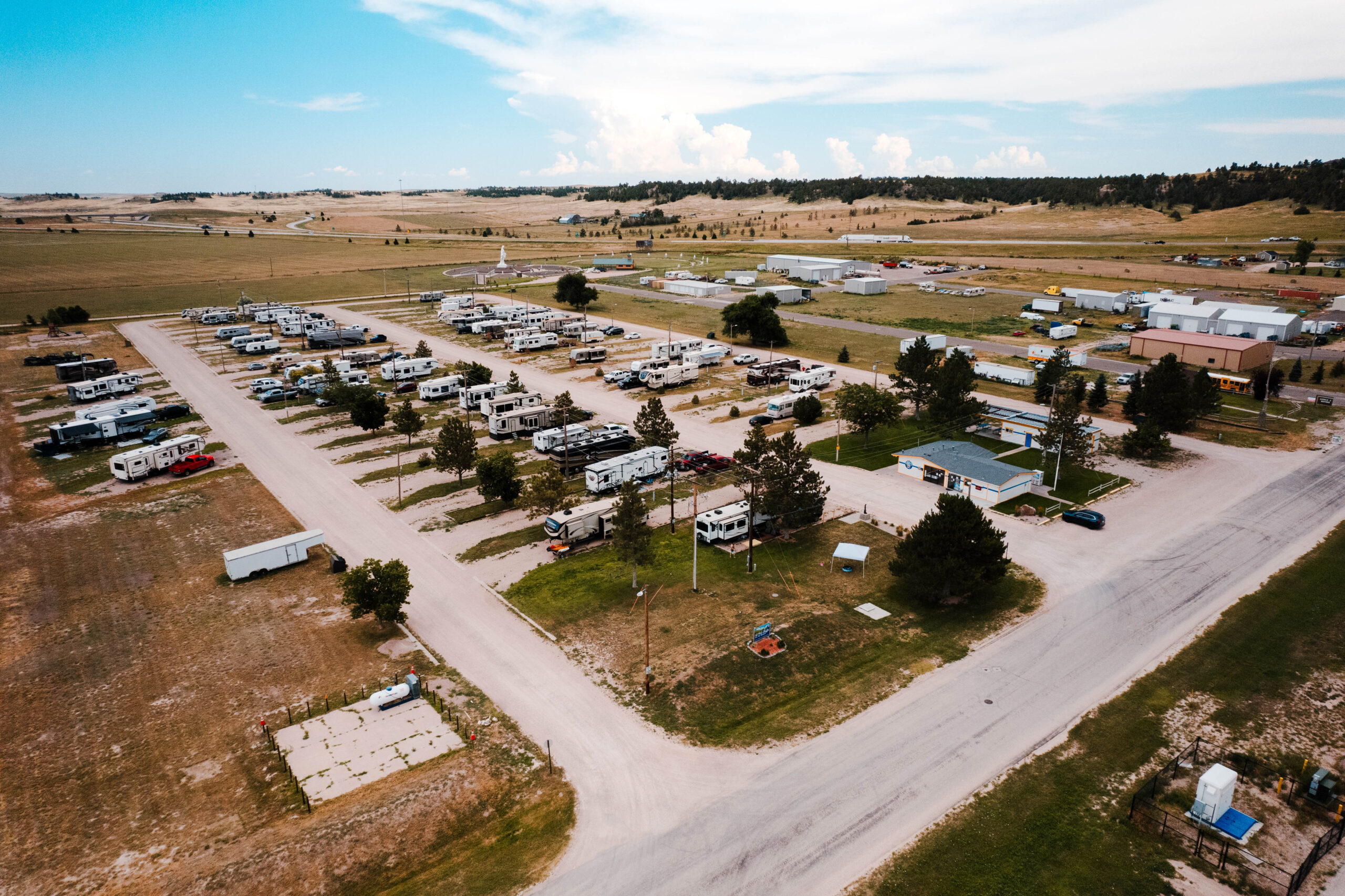 Panoramic view of Pine Bluffs RV Resort by RJourney with open Wyoming sky and full hookup sites