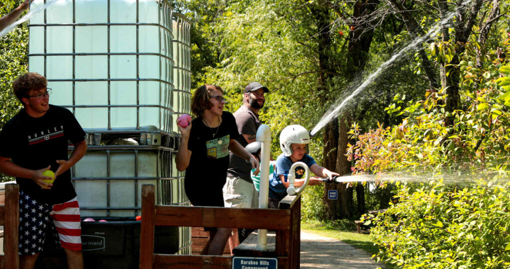 Campers have an epic water fight at Baraboo RV Resort by RJourney.