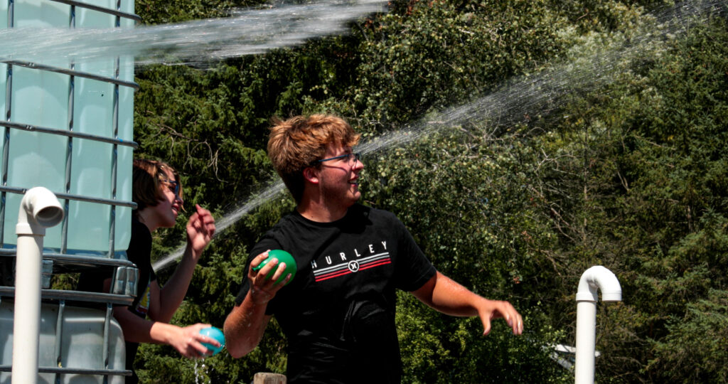 Teens water fighting.
