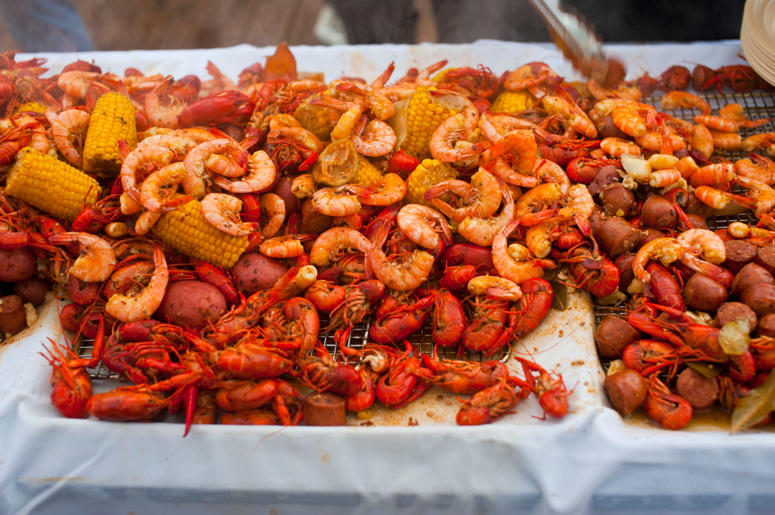 Crawfish boils. Louisiana, New Orleans Crawfish Boil. Crawfish, shrimp, lobster, seafood, corn on the cob, sausage, potatoes boiled in Cajun seasonings and herbs. Classic Cajun or Creole cuisine.