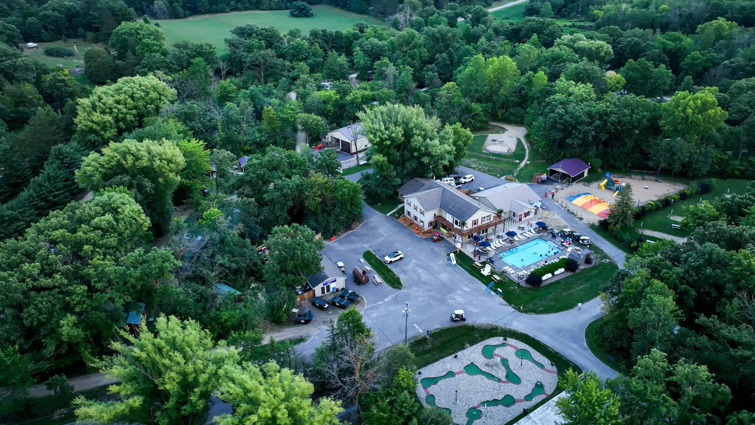 Aerial view of Baraboo RV Resort by RJourney with tree-lined campsites in Baraboo, Wisconsin