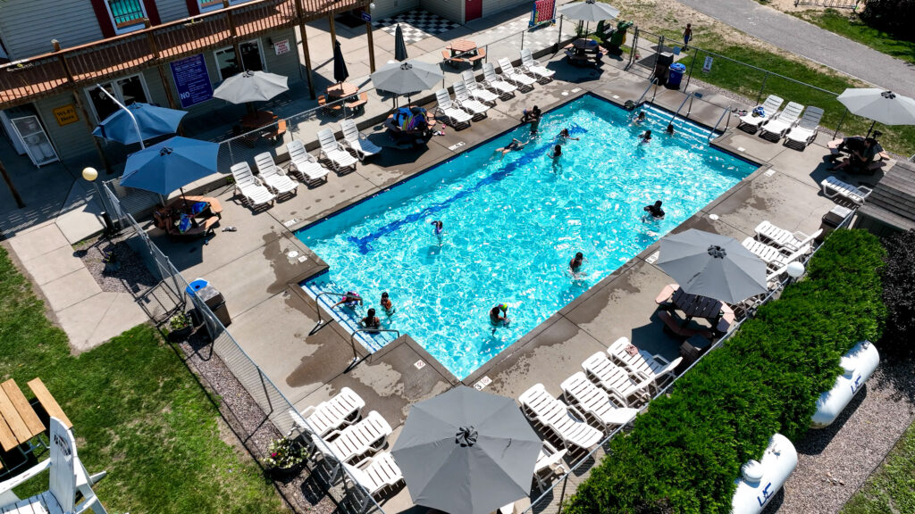Aerial view of people swimming in the pool at Baraboo RV Resort by RJourney. 