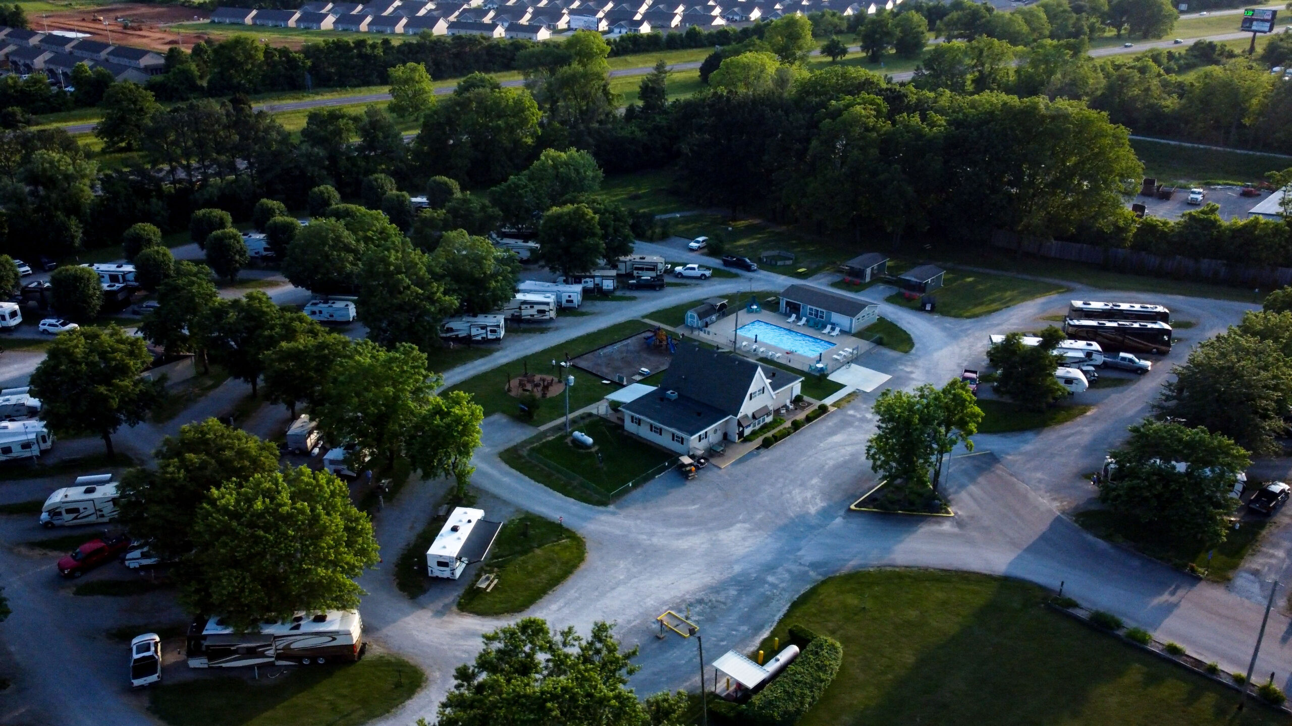Aerial view of Clarksville RV Resort by RJourney showing pull-through sites and mature trees off Tylertown Road, a mile from I-24 Exit 1 in Clarksville, Tennessee