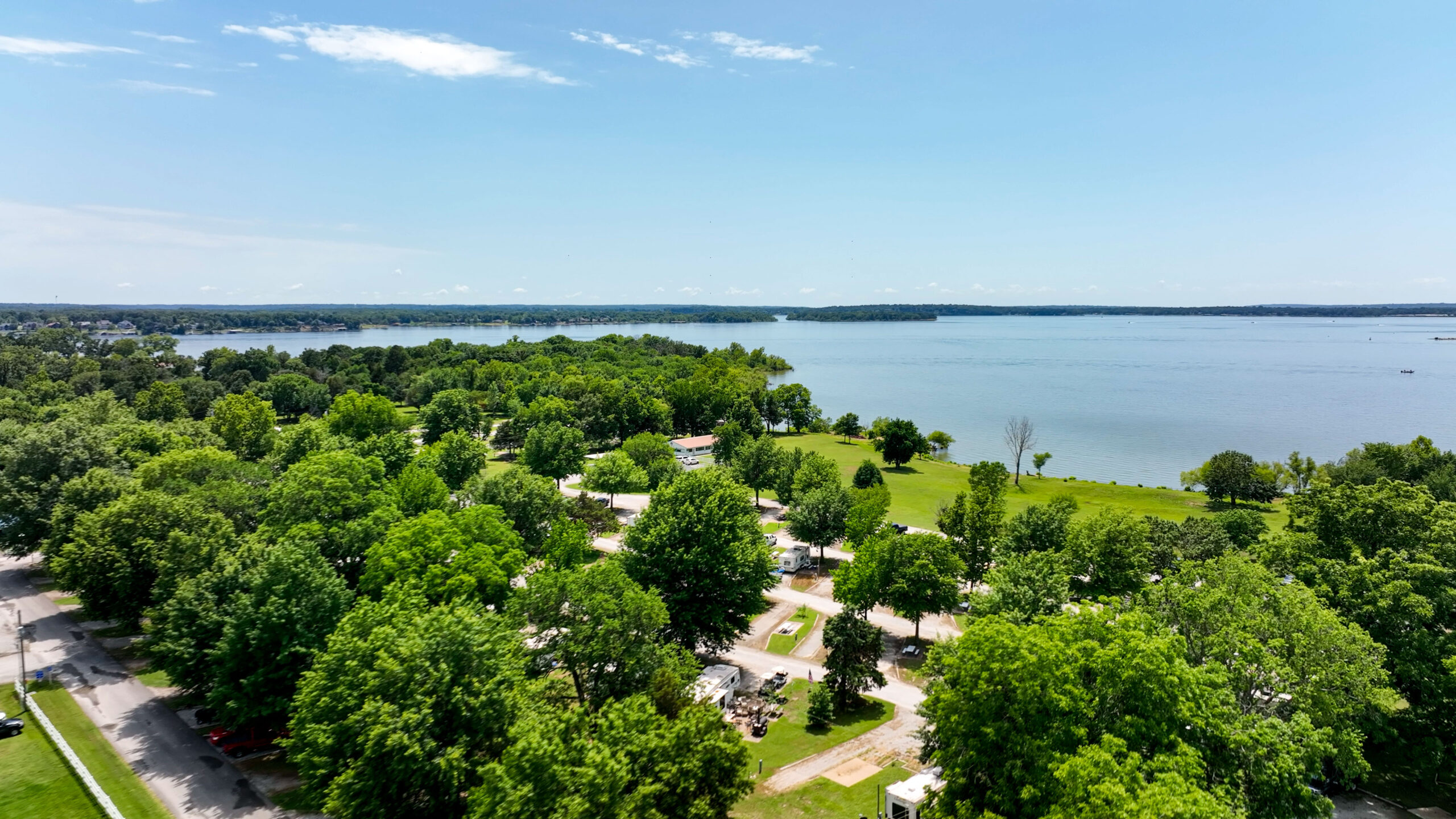 Aerial view of lakefront RV sites and Grand Lake shoreline at Grand Lake O' the Cherokees RV Resort in Grove, Oklahoma