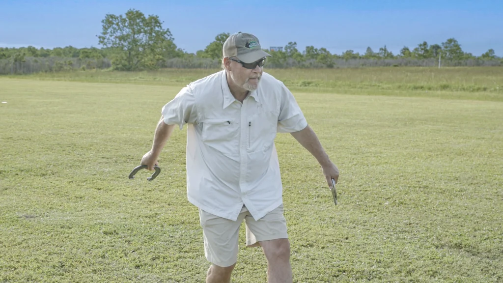 A man plays horseshoes at Lake Charles RV Resort by RJourney