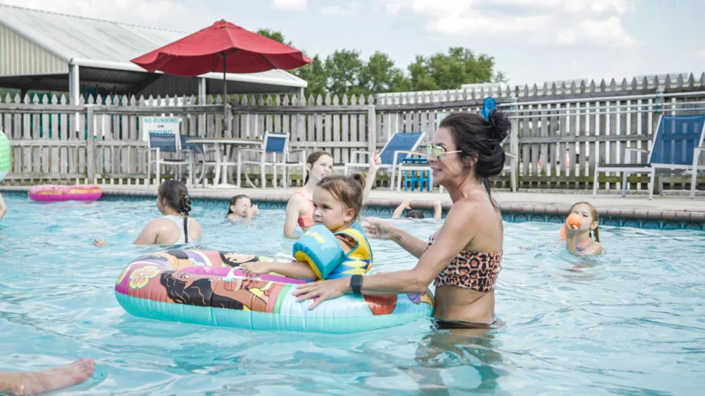 A woman plays with her children at the Lakeside RV Resort pool.