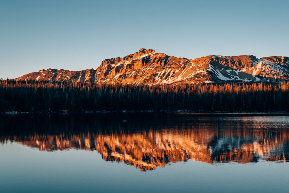 Snowy mountains reflecting while camping near Mirror Lake, in the Uinta Mountains, Utah