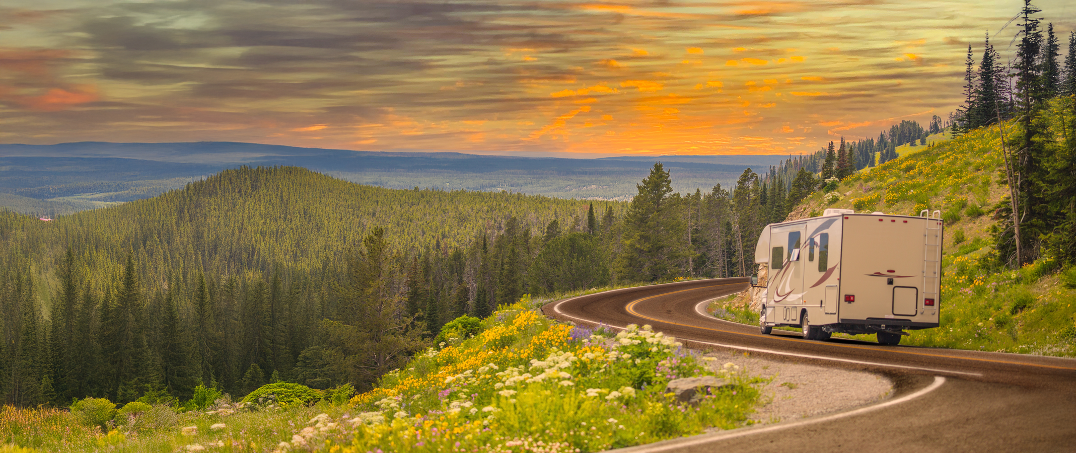 An RV drives around the bend on an open American road.