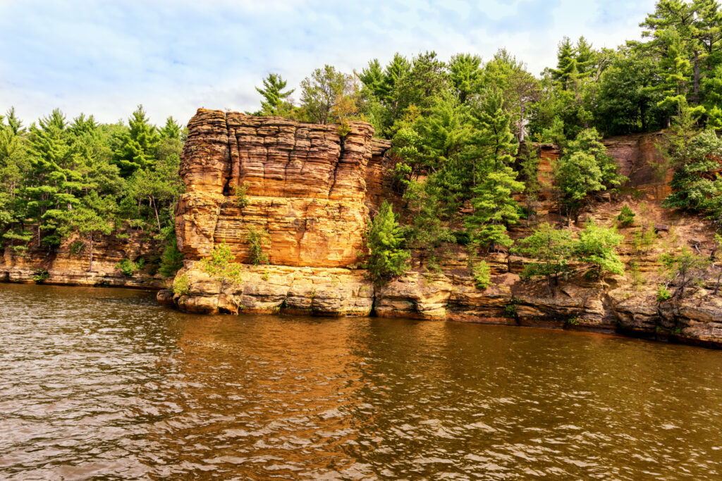 Rock formations along the Wisconsin river are seen by being on an upper dells boat tour.