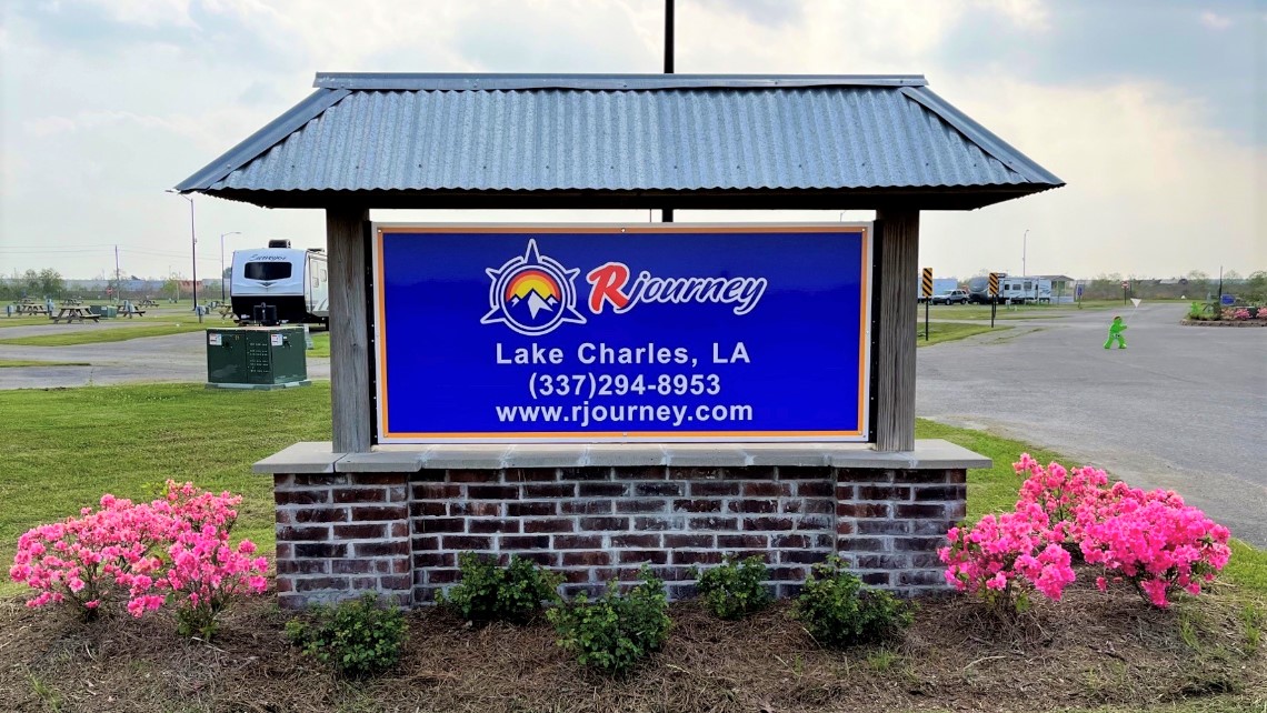 Pull-through RV sites with concrete pads and paved streets at Lake Charles RV Resort in Iowa, LA