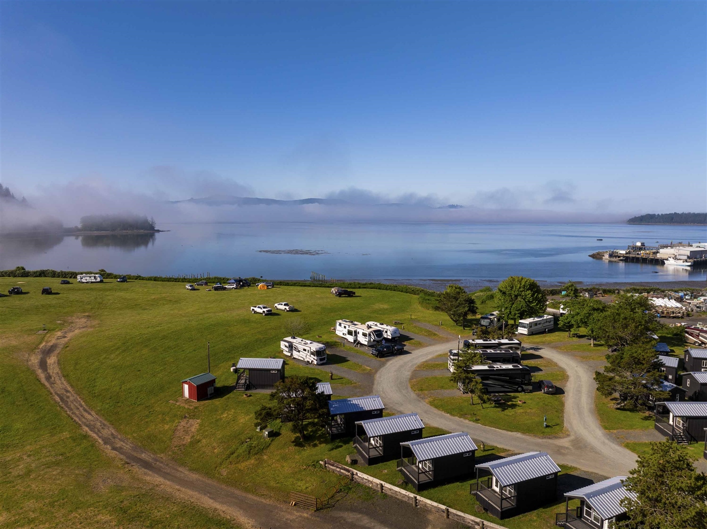 Bay view of full-hookup RV sites at Roam Tillamook RV Resort on Tillamook Bay in Garibaldi, Oregon