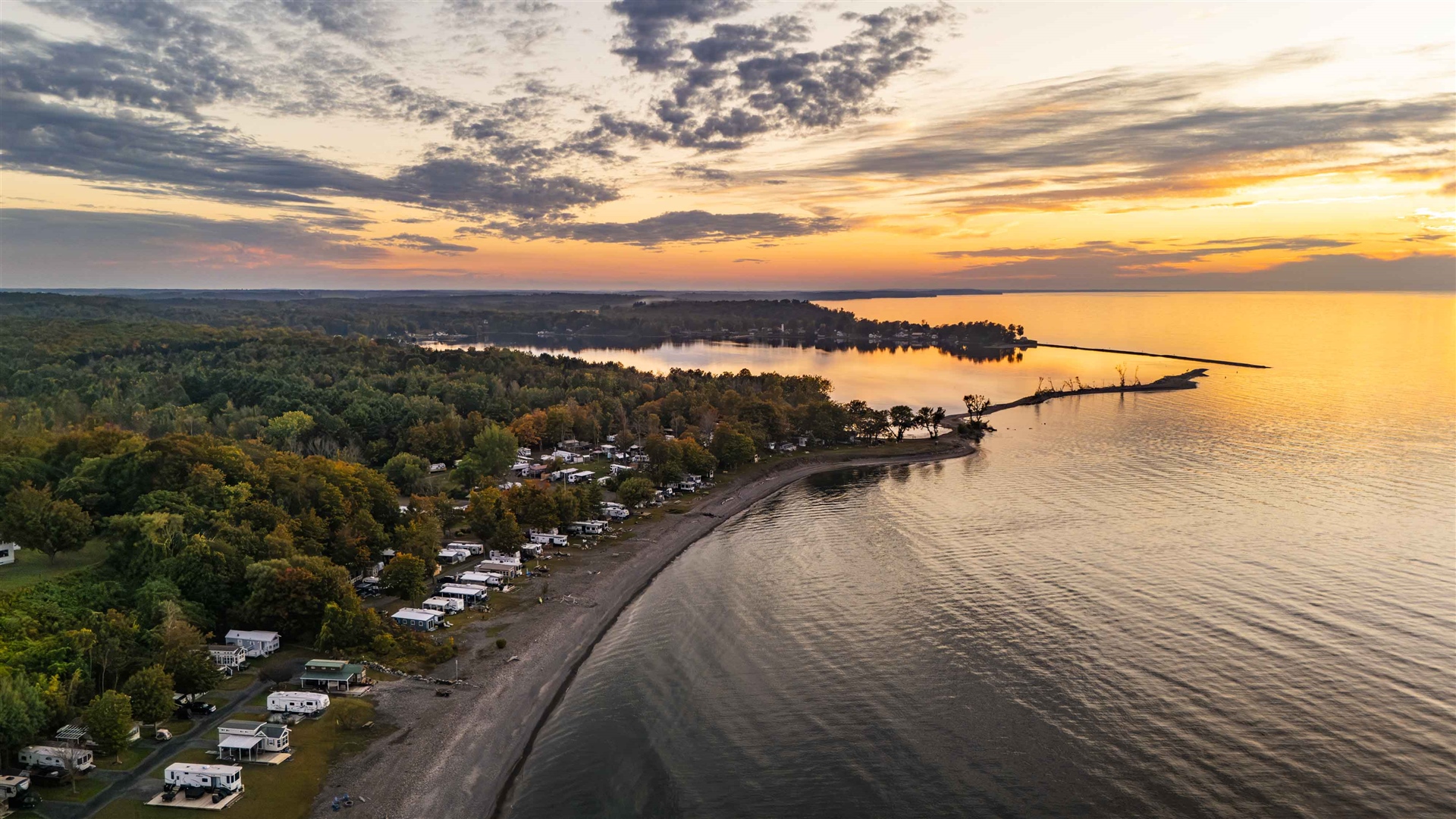 RV sites with hookups and shaded grounds at Shady Shores RV Resort & Campground in Fair Haven, New York