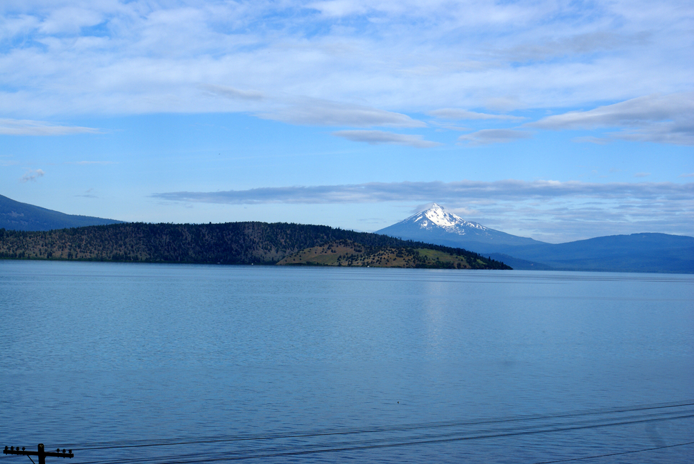 Upper Klamath Lake, shallow freshwater lake east of Cascade Range in south-central Oregon, USA , rich in fish, blue green algae, snow covered peak of  Mt. McLoughlin in background.                  